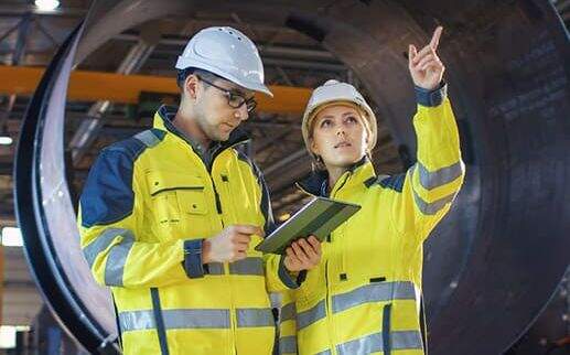 Image of two people looking at the fabrication of a product
