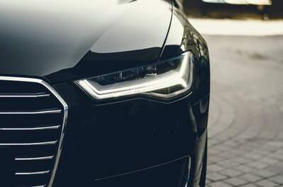 Photograph of black car monitored by advanced automotive sensors